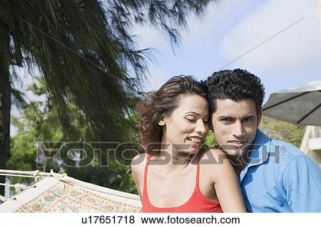 Close-up of a young couple smiling View Large Photo Image Stock Photo - Close-up of a young couple smiling. Fotosearch