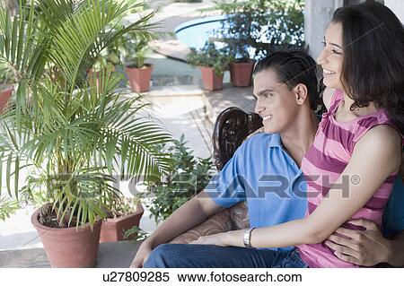 Close-up of a young couple smiling View Large Photo Image Stock Photography - Close-up of a young couple smiling. Fotosearch