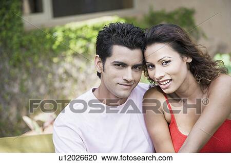 Stock Image - Portrait of a young couple smiling. Fotosearch