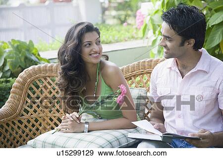 Young couple looking at each other and smiling View Large Photo Image Stock Photo - Young couple looking at each other and smiling. Fotosearch