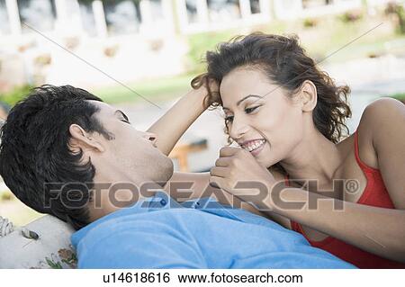 Young couple lying in a hammock and smiling View Large Photo Image Stock Photograph - Young couple lying in a hammock and smiling. Fotosearch