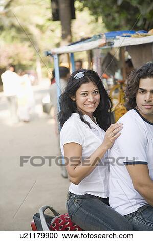 Stock Image - Young couple sitting on a motorcycle. Fotosearch