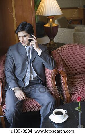 Businessman talking on a mobile phone View Large Photo Image Picture - Businessman talking on a mobile phone. Fotosearch