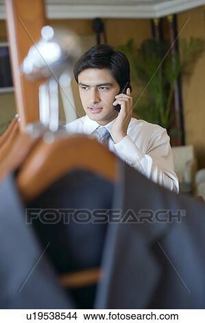 Picture - Businessman talking on a mobile phone. Fotosearch