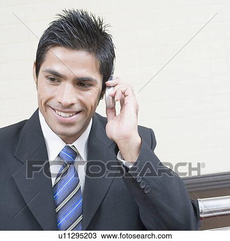 Close-up of a businessman talking on a mobile phone View Large Photo Image Stock Image - Close-up of a businessman talking on a mobile phone. Fotosearch