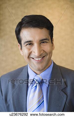 Stock Image - Portrait of a businessman smiling. Fotosearch