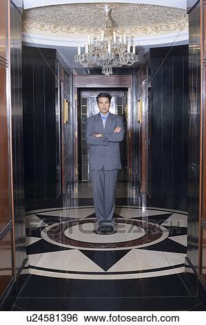Portrait of a businessman standing with his arms crossed View Large Photo Image Stock Photograph - Portrait of a businessman standing with his arms crossed. Fotosearch