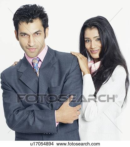 Picture - Portrait of a young woman standing with a young man and smiling. Fotosearch