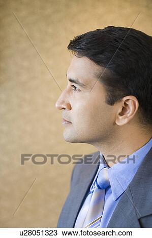 Side profile of a businessman looking away View Large Photo Image Stock Image - Side profile of a businessman looking away. Fotosearch