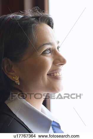 Side profile of a businesswoman smiling View Large Photo Image Picture - Side profile of a businesswoman smiling. Fotosearch