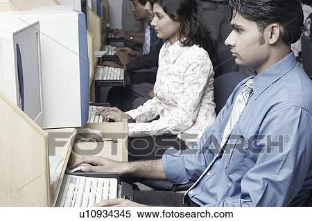 Side profile of two office workers working in an office View Large Photo Image Stock Photography - Side profile of two office workers working in an office. Fotosearch