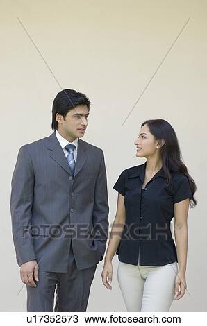 Businessman and a businesswoman talking to each other View Large Photo Image Stock Image - Businessman and a businesswoman talking to each other. Fotosearch
