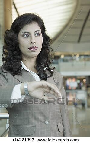 Businesswoman standing at an airport View Large Photo Image Stock Photo - Businesswoman standing at an airport. Fotosearch