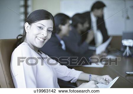 Portrait of a businesswoman sitting in a conference room View Large Photo Image Stock Image - Portrait of a businesswoman sitting in a conference room. Fotosearch