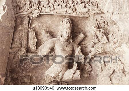 Stock Photograph - Close-up of a sculpture curved on the wall of a cave, Elephanta Caves, Mumbai, Maharashtra, India. Fotosearch