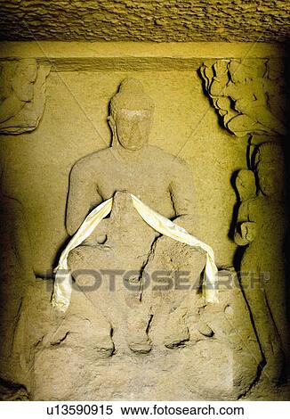 Close-up of a statue of Buddha carved on the wall of a cave, Kanari Cave, Mumbai, Maharashtra, India View Large Photo Image Stock Photography - Close-up of a statue of Buddha carved on the wall of a cave, Kanari Cave, Mumbai, Maharashtra, India. Fotosearch