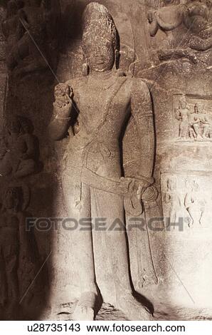 Statue carved on the wall in a cave, Ellora, Aurangabad, Maharashtra, India View Large Photo Image Stock Image - Statue carved on the wall in a cave, Ellora, Aurangabad, Maharashtra, India. Fotosearch