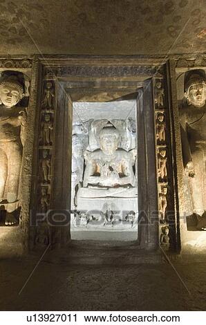 Stock Image - Statue of Buddha in a cave, Ajanta, Maharashtra, India. Fotosearch