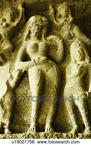 Statues carved on the wall in a cave, Ellora, Aurangabad, Maharashtra, India View Large Photo Image Stock Photo - Statues carved on the wall in a cave, Ellora, Aurangabad, Maharashtra, India. Fotosearch
