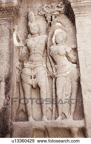 Statues of lord Shiva and goddess Parvati carved in a cave, Ellora, Aurangabad, Maharashtra, India View Large Photo Image Stock Photo - Statues of lord Shiva and goddess Parvati carved in a cave, Ellora, Aurangabad, Maharashtra, India. Fotosearch