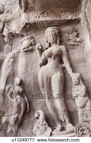 Stock Photo - Statues on the wall in a cave, Ellora, Aurangabad, Maharashtra, India. Fotosearch