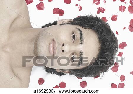 High angle view of a young man lying on a massage table View Large Photo Image Stock Photo - High angle view of a young man lying on a massage table. Fotosearch