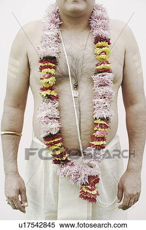 Mid section view of a priest wearing a garland View Large Photo Image Stock Photography - Mid section view of a priest wearing a garland. Fotosearch