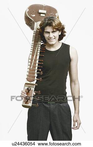 Portrait of a male musician holding a sitar View Large Photo Image Picture - Portrait of a male musician holding a sitar. Fotosearch