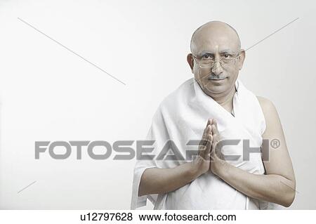 Stock Photo - Portrait of a mature man in a prayer position. Fotosearch
