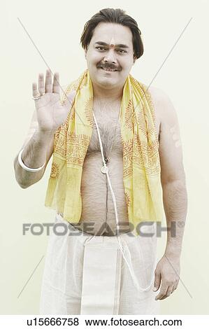Stock Photo - Portrait of a priest giving blessings. Fotosearch