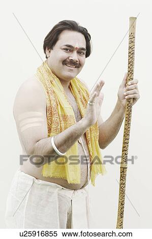 Portrait of a priest holding a stick View Large Photo Image Stock Photography - Portrait of a priest holding a stick. Fotosearch