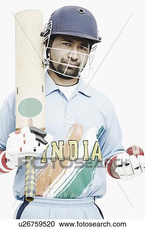 Portrait of a young man holding a cricket bat and a cricket ball View Large Photo Image Stock Image - Portrait of a young man holding a cricket bat and a cricket ball. Fotosearch