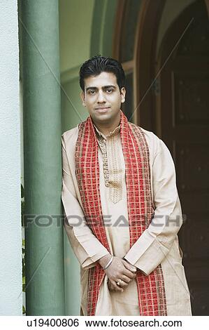 Portrait of a young man leaning against a column View Large Photo Image Stock Photograph - Portrait of a young man leaning against a column. Fotosearch