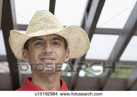 Portrait of a young man wearing a straw hat View Large Photo Image Picture - Portrait of a young man wearing a straw hat. Fotosearch