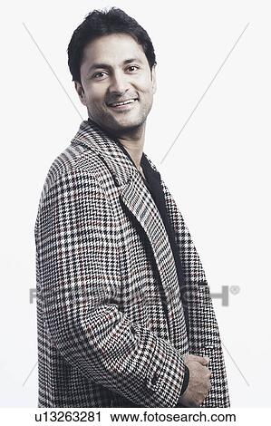 Stock Image - Side profile of a mid adult man smiling. Fotosearch