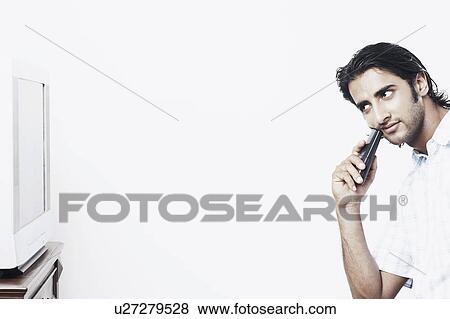 Side profile of a young man watching TV View Large Photo Image Stock Photo - Side profile of a young man watching TV. Fotosearch