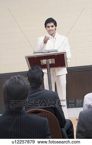 Stock Photo - Businessman giving presentation in a conference room. Fotosearch