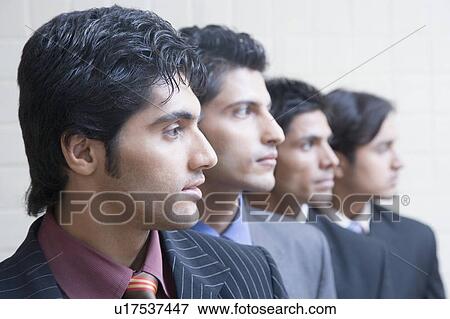 Close-up of four businessmen in a row View Large Photo Image Stock Photo - Close-up of four businessmen in a row. Fotosearch