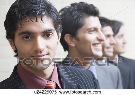 Stock Photography - Close-up of four businessmen smiling. Fotosearch