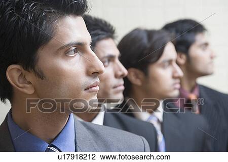 Stock Image - Four businessmen in a row. Fotosearch