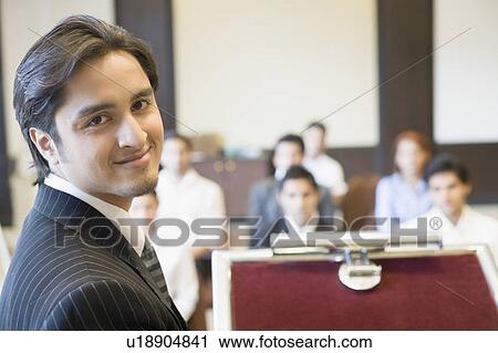 Portrait of a businessman at a lectern View Large Photo Image Stock Image - Portrait of a businessman at a lectern. Fotosearch