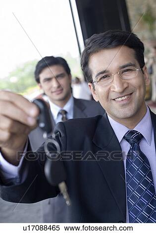 Portrait of a businessman showing a key and smiling View Large Photo Image Stock Photography - Portrait of a businessman showing a key and smiling. Fotosearch