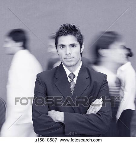 Stock Photo - Portrait of a businessman standing with his arms crossed. Fotosearch