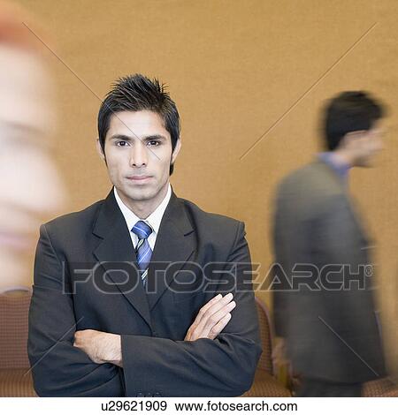 Portrait of a businessman standing with his arms crossed View Large Photo Image Stock Photo - Portrait of a businessman standing with his arms crossed. Fotosearch