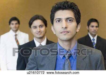 Portrait of a businessman with three business executives standing behind him View Large Photo Image Stock Image - Portrait of a businessman with three business executives standing behind him. Fotosearch
