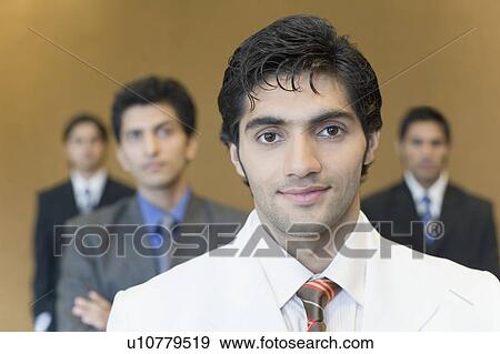Portrait of a businessman with three business executives standing behind him View Large Photo Image Stock Photo - Portrait of a businessman with three business executives standing behind him. Fotosearch