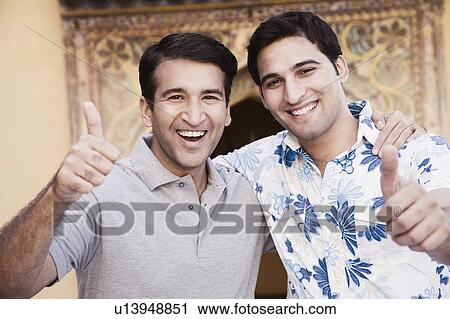 Portrait of a mid adult man and a young man showing a thumbs up sign View Large Photo Image Stock Image - Portrait of a mid adult man and a young man showing a thumbs up sign. Fotosearch