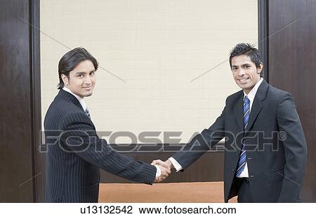 Portrait of two businessmen shaking their hands View Large Photo Image Stock Image - Portrait of two businessmen shaking their hands. Fotosearch