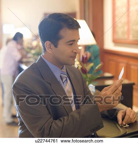 Side profile of a businessman holding a visiting card View Large Photo Image Stock Image - Side profile of a businessman holding a visiting card. Fotosearch