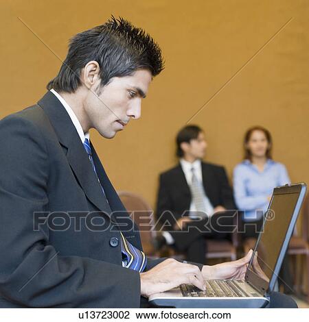 Side profile of a businessman using a laptop View Large Photo Image Stock Image - Side profile of a businessman using a laptop. Fotosearch
